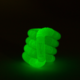 Green glow-in-the-dark Tangle Jr. scaly fidget toy glowing bright green in the dark