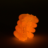 Purple glow-in-the-dark Tangle Jr. textured fidget toy glowing bright green in the dark