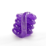 Purple glow-in-the-dark Tangle Jr. fidget toy with patterned textured segments, coiled into a stack
