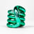 Green metallic Tangle Jr. fidget toy coiled into its resting spiral shape showing chrome finish
