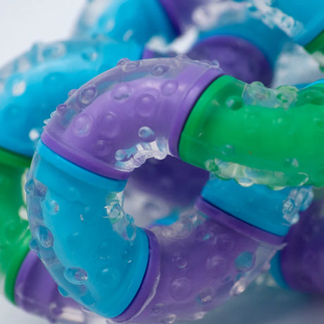 closeup of translucent textured tangle fidget toy in blue purple green segments