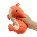 Hand squeezing The Big Squij giant shrimp slow rise squishy in coral and cream