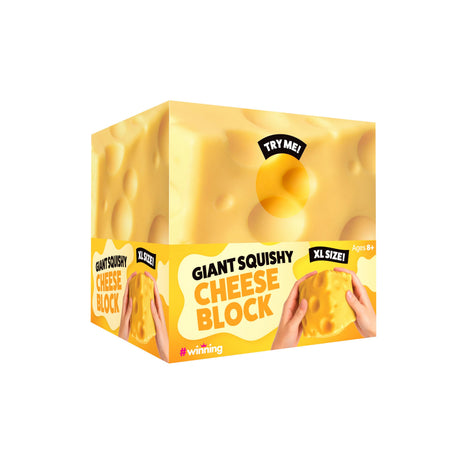 A novelty toy cheese block shaped like a square block of Swiss cheese, featuring a yellow and orange color scheme with text reading 'GIANT SQUISHY CHEESE BLOCK' and 'XL SIZE!'.