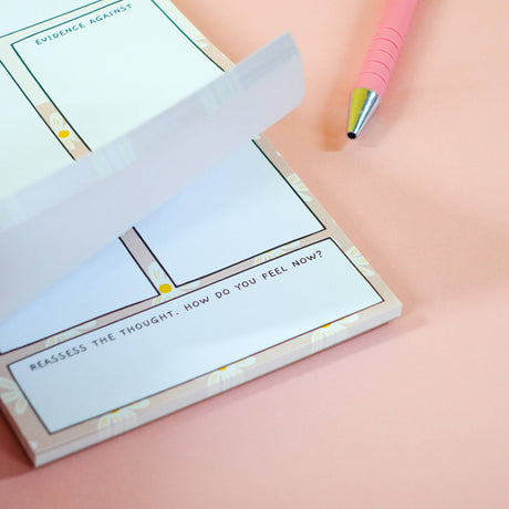 Thoughts vs Facts notepad pages fanned showing multiple sheets, anxiety tool stationery