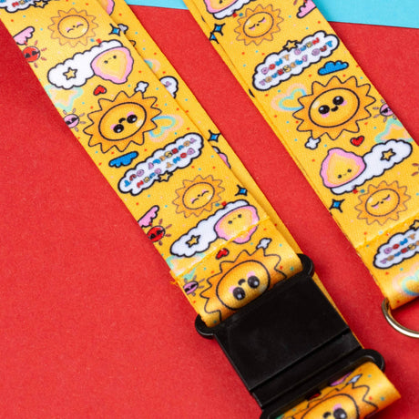 Yellow strap with cartoon sun and cloud designs on a red background