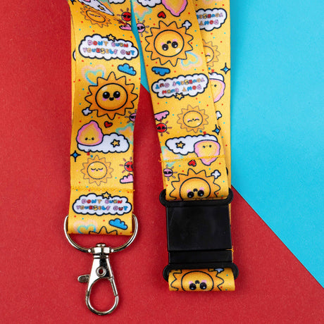 Lanyard with cartoon sun and cloud design on a red and blue background