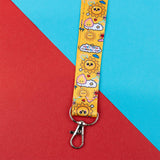 Yellow lanyard with cartoon sun design on a red and blue background