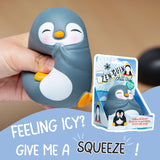 Hand holding the Zen-Guin penguin squishy next to its blue Arctic-themed gift box