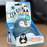 Kawaii penguin squishy stress toy in its blue Zen-Guin Chill Out gift box on a desk